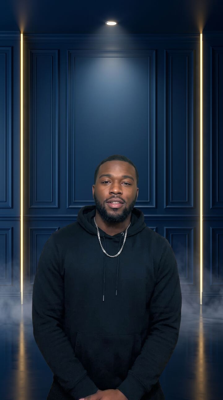 Same creator standing inside a designed midnight blue live room with gold light strips